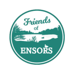circle logo with text &#039;friends of ensors&#039; with a small pond in the middle of a grassy bank.